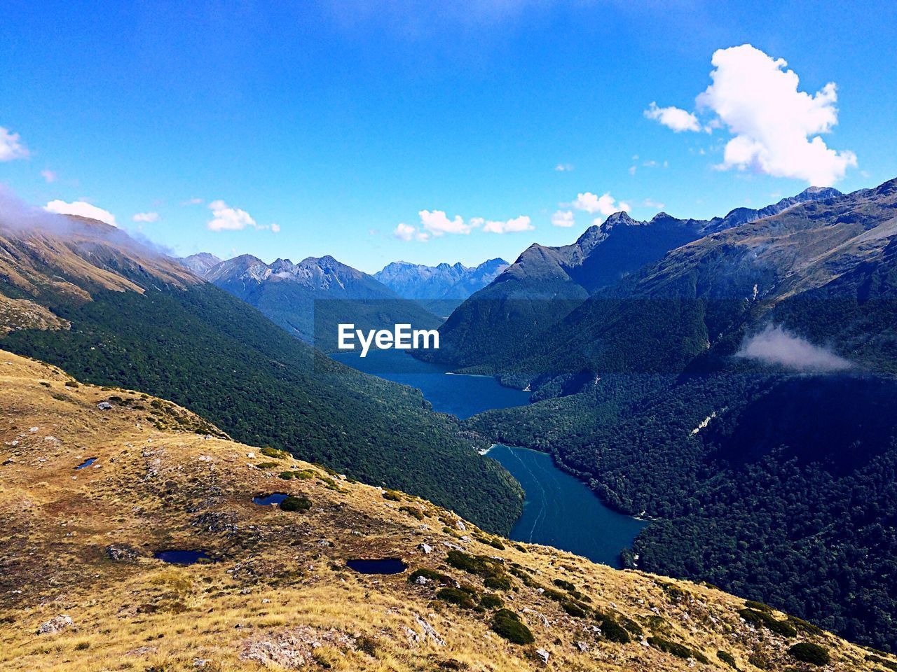 Scenic view of mountains against blue sky