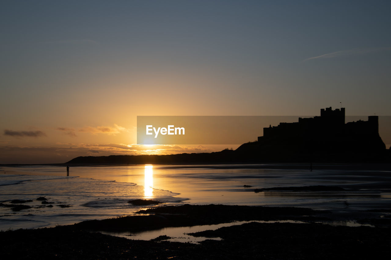 SCENIC VIEW OF SEA AGAINST ORANGE SKY