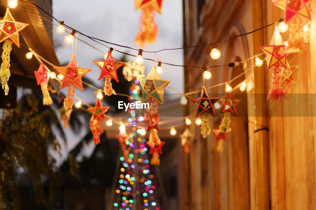 Low angle view of illuminated decorations hanging during christmas