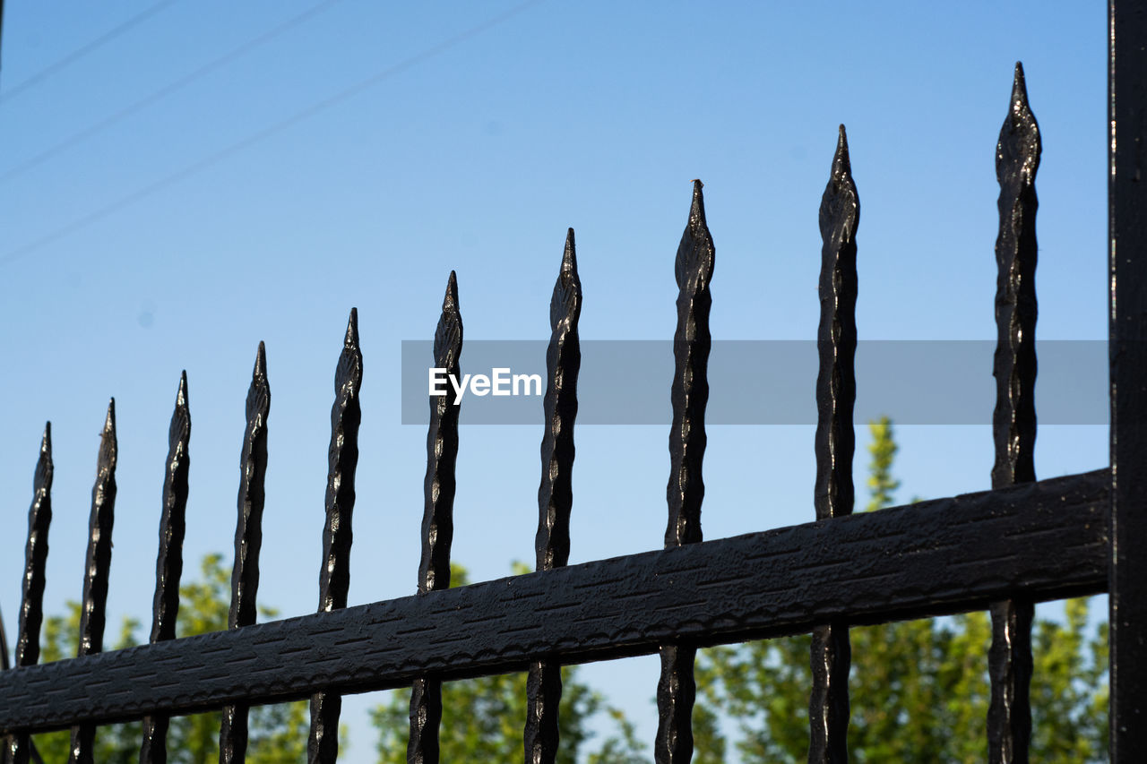 LOW ANGLE VIEW OF WOODEN FENCE AGAINST BLUE SKY