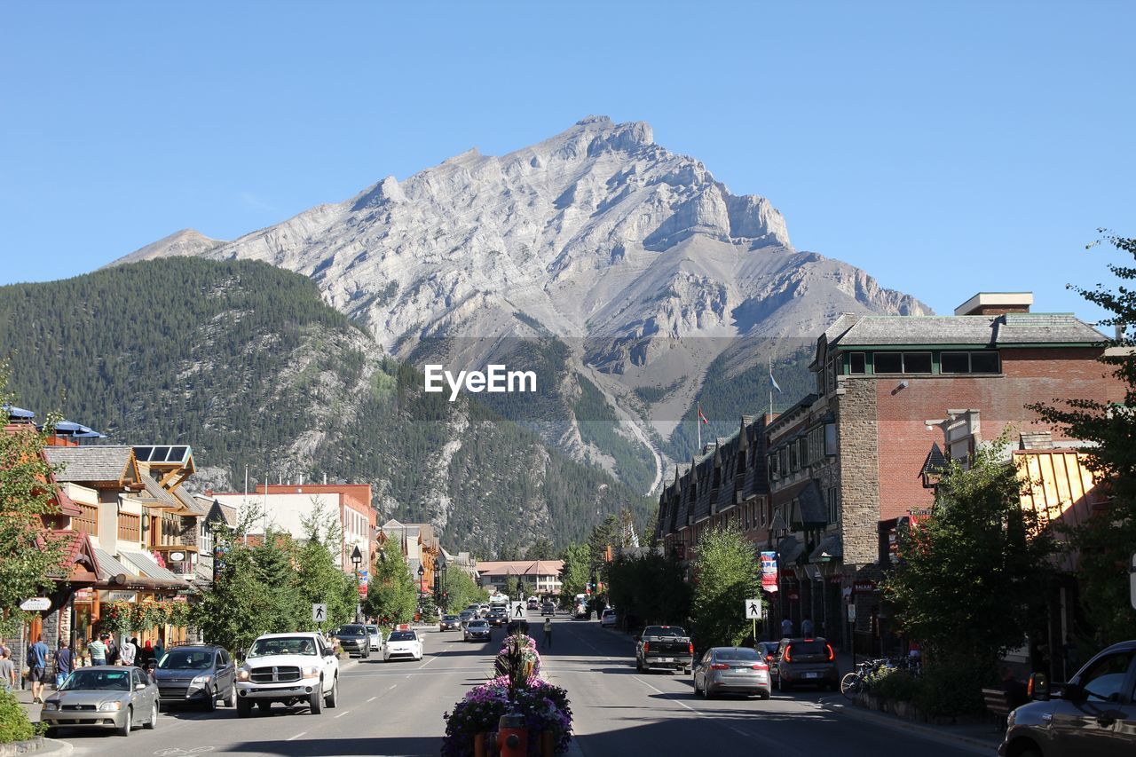 Cars on road against mountain range