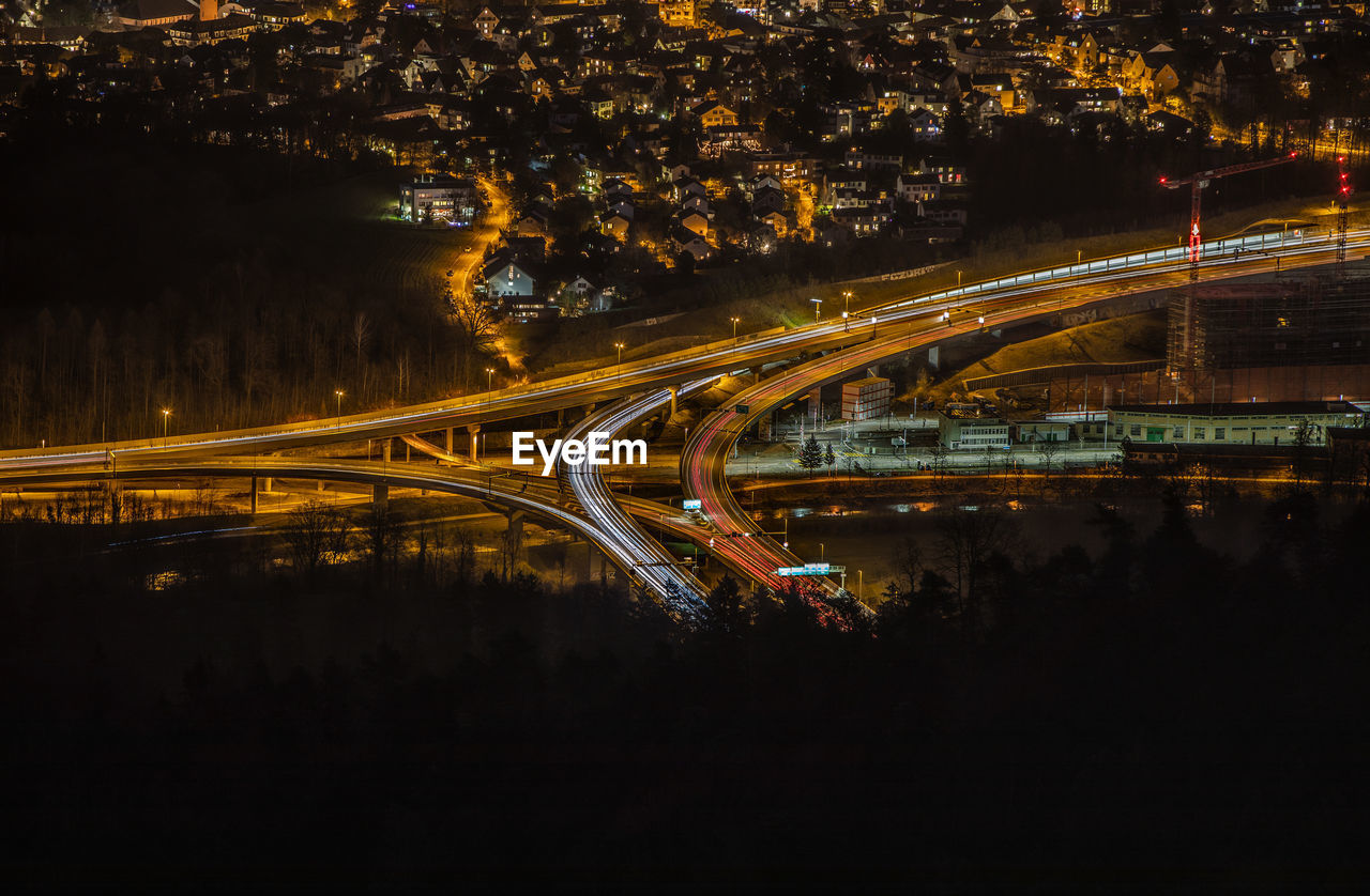 Light trails on bridge over city at night