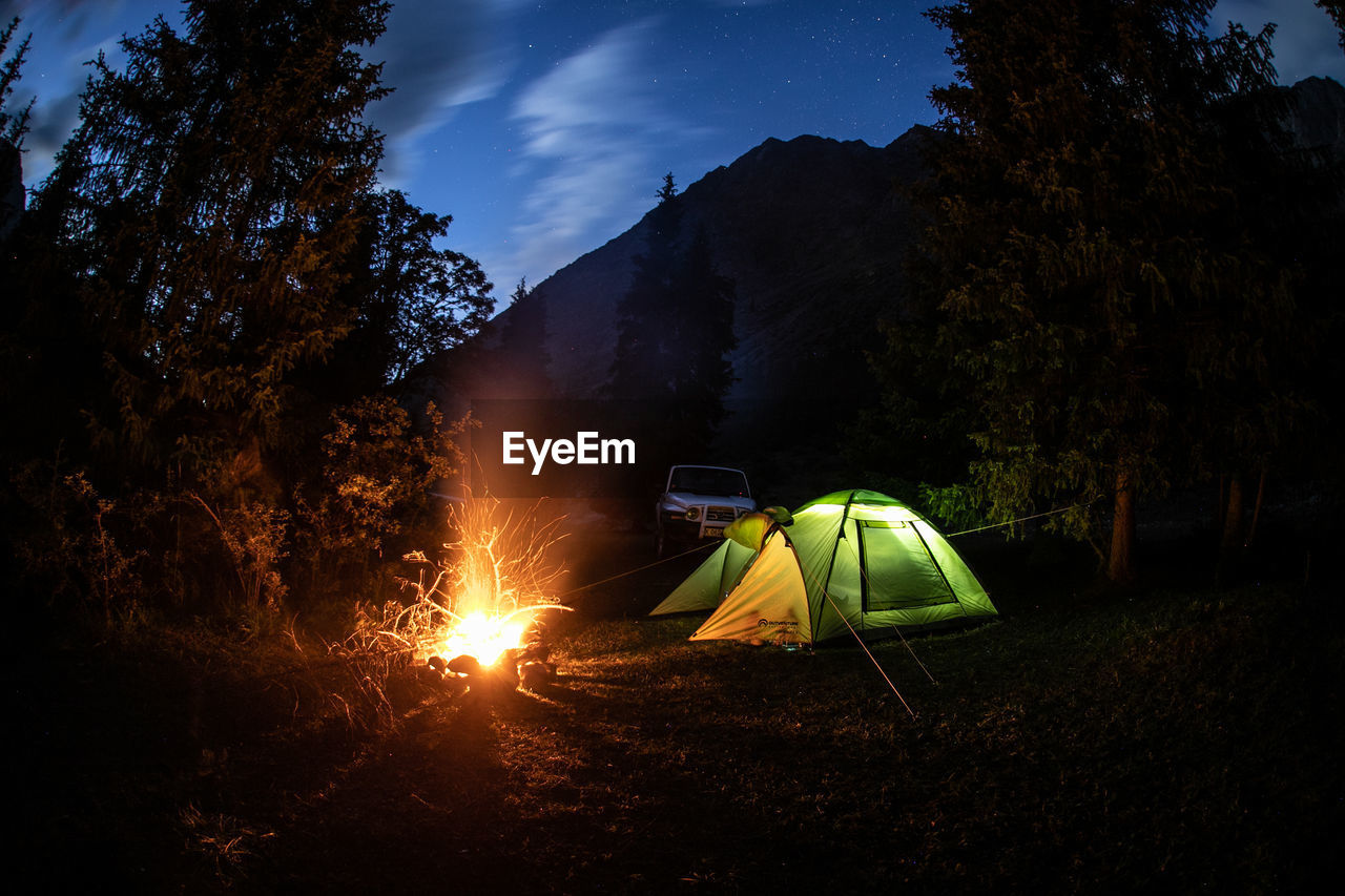 TENT ON FIELD AGAINST SKY AT NIGHT