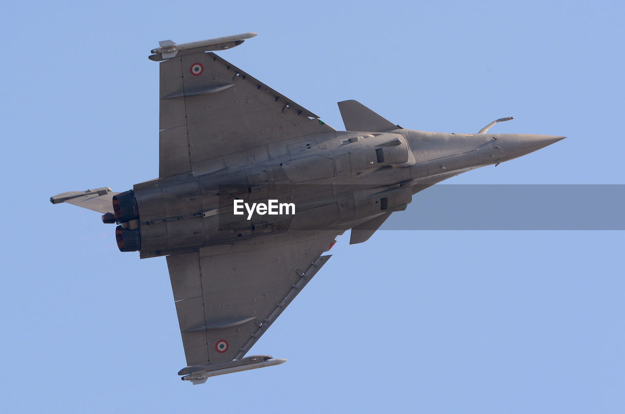 Low angle view of fighter plane against clear sky