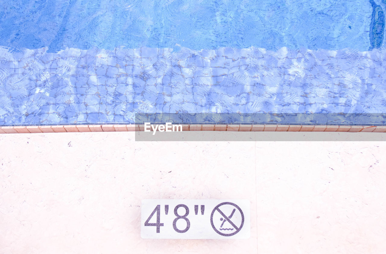 High angle view of text on wall by swimming pool