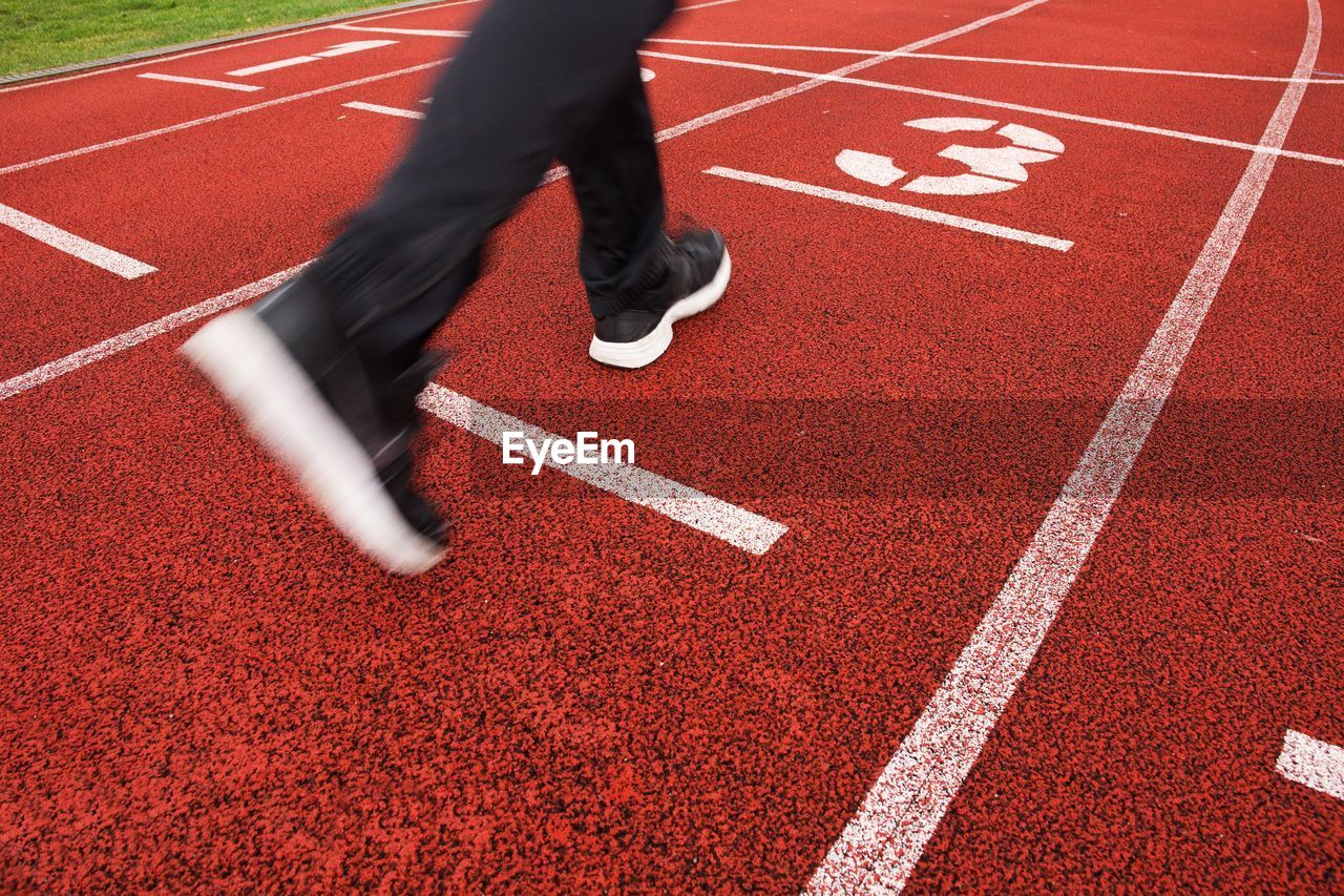 Red running racetrack on the stadium with two running legs