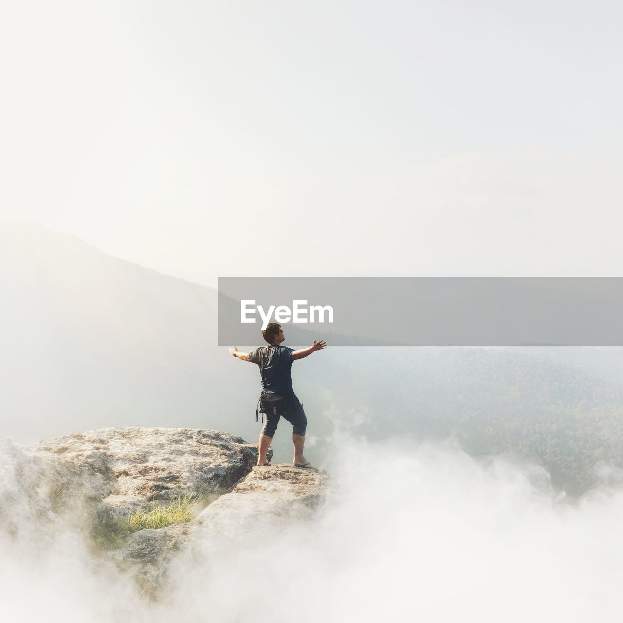 Full length of man standing on mountain against sky