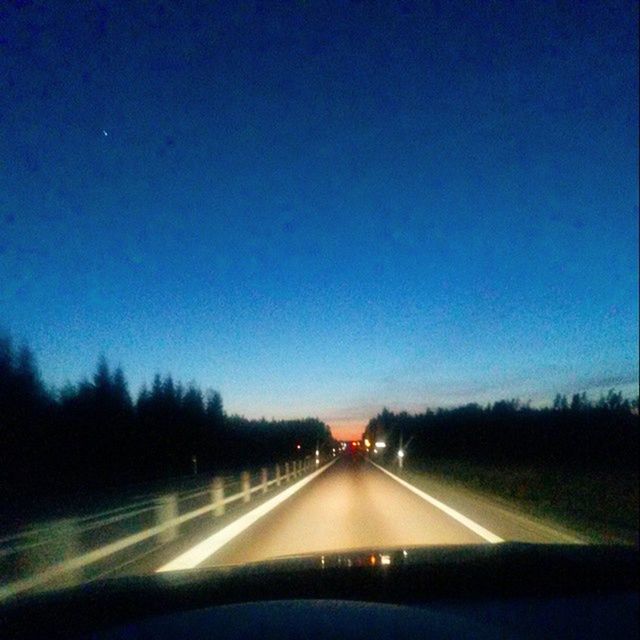 ROAD PASSING THROUGH CAR WINDSHIELD