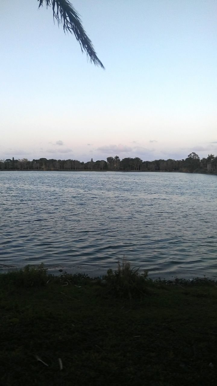 SCENIC VIEW OF LAKE AGAINST SKY AT SUNSET
