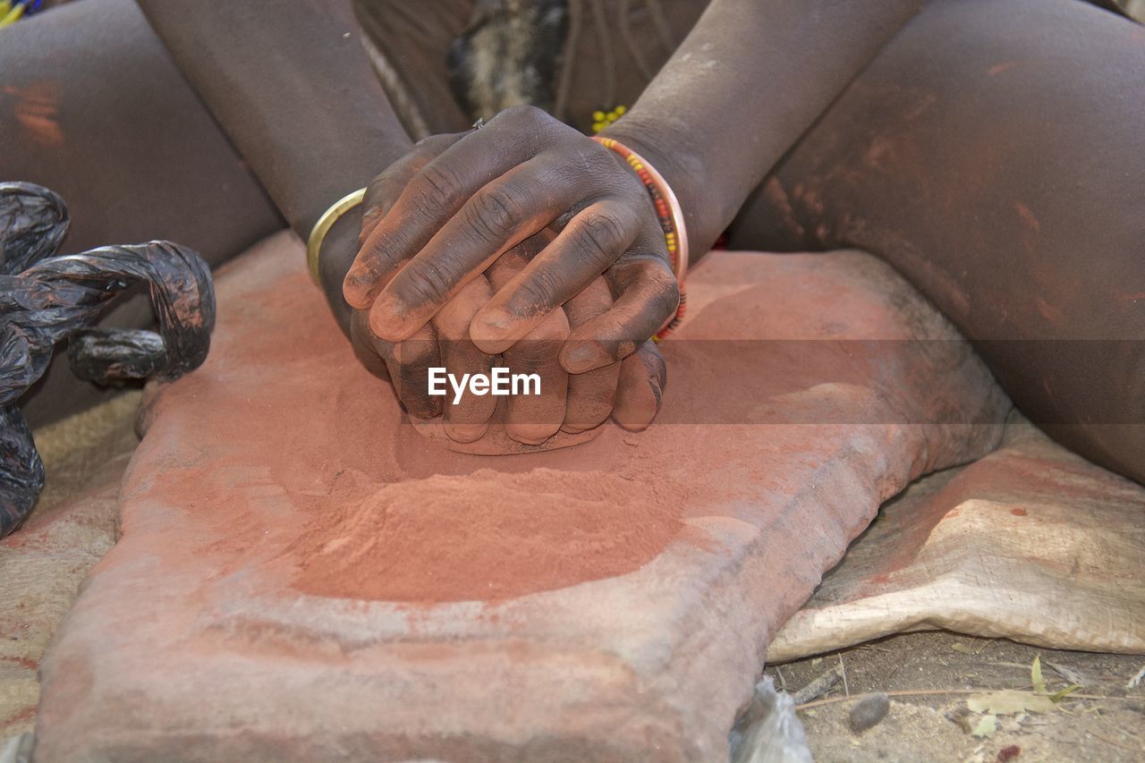 Midsection of man working on stone