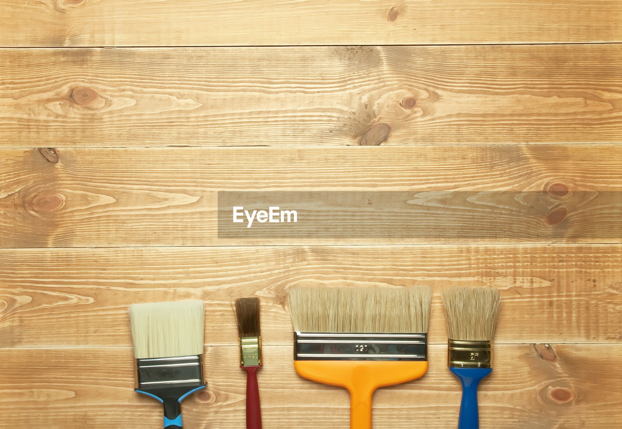 CLOSE-UP OF TOOLS ON WOODEN FLOOR