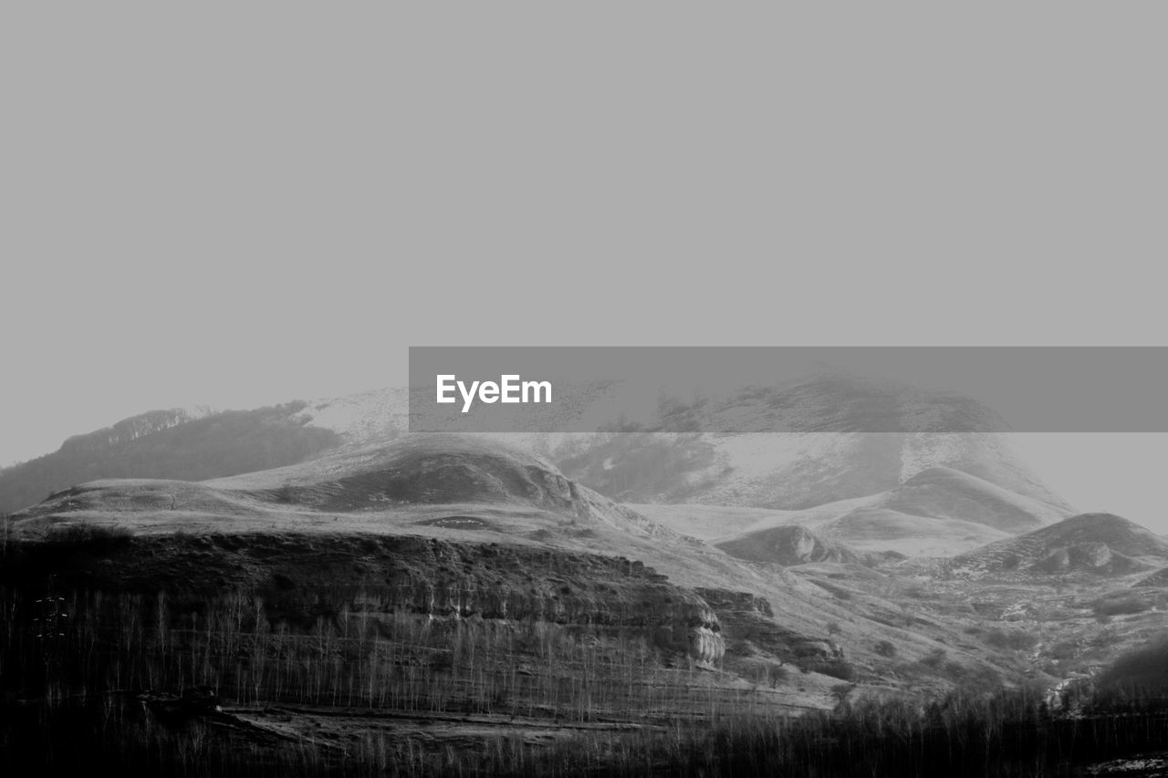 Scenic view of mountains against cloudy sky