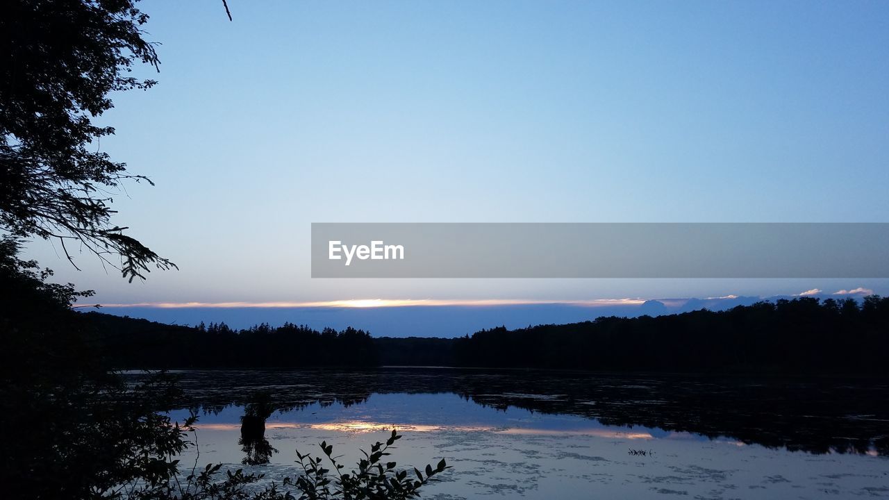 SCENIC VIEW OF LAKE AGAINST CLEAR SKY DURING WINTER