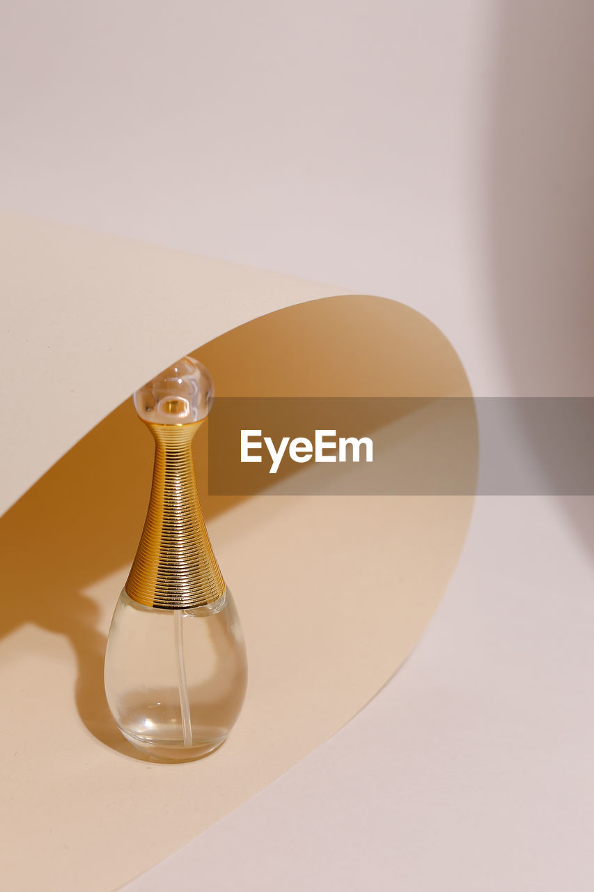 Close-up of perfume on colored background