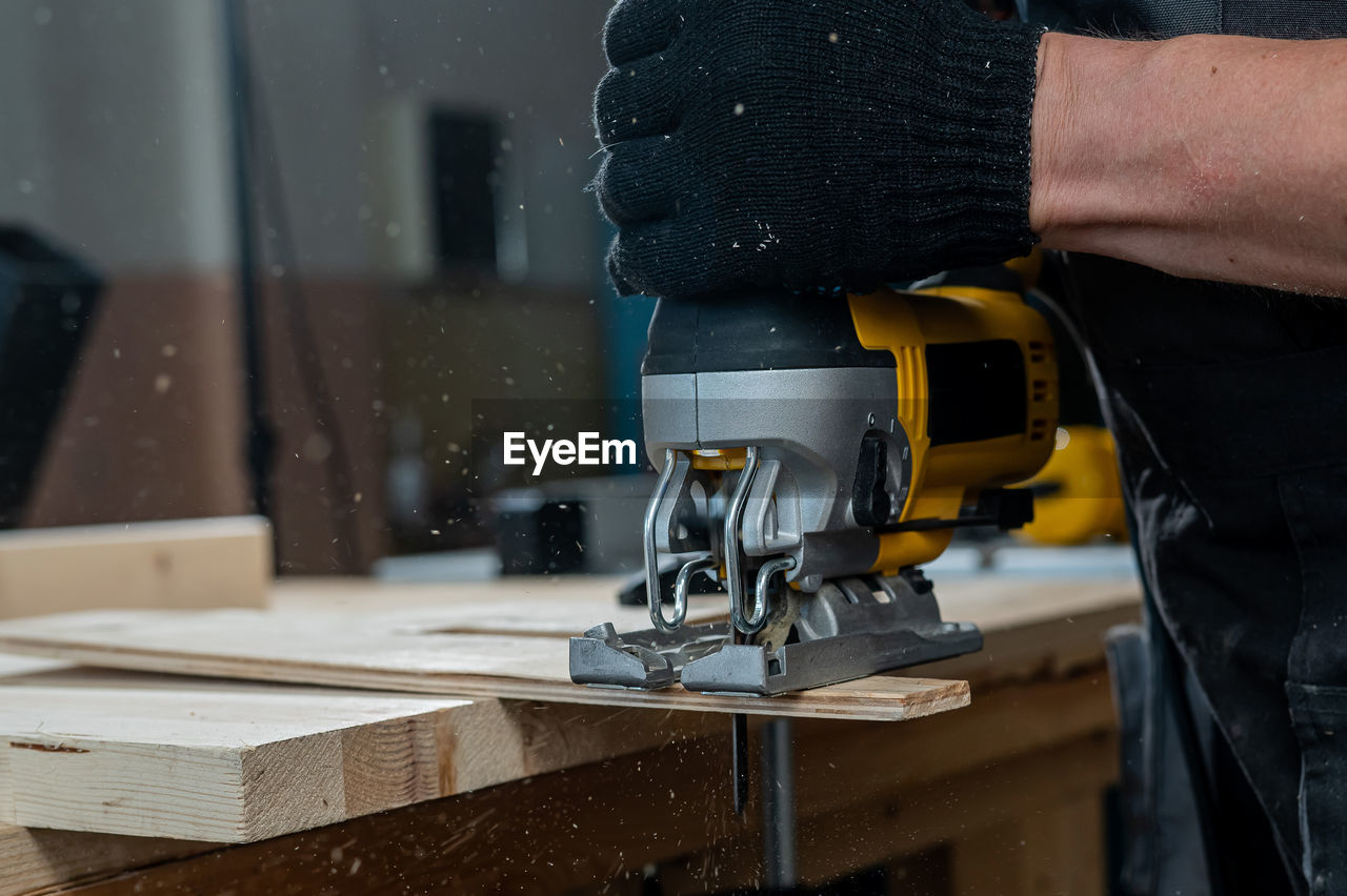 low section of man working in workshop