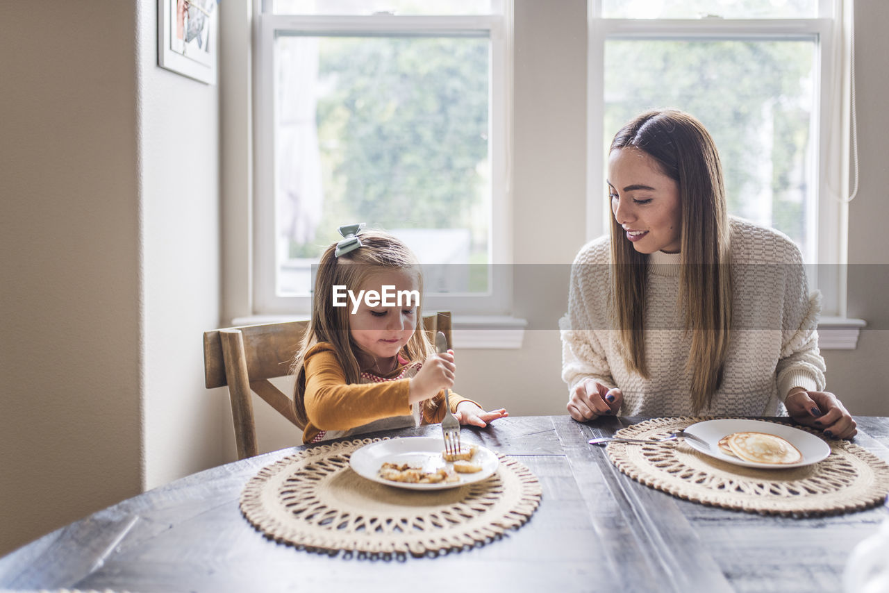 Multigenerational family eating pancakes for breakfast