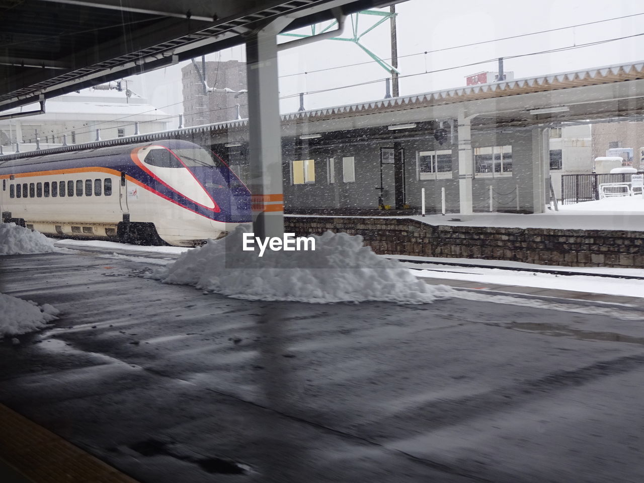 TRAIN ON SNOW COVERED RAILROAD TRACK