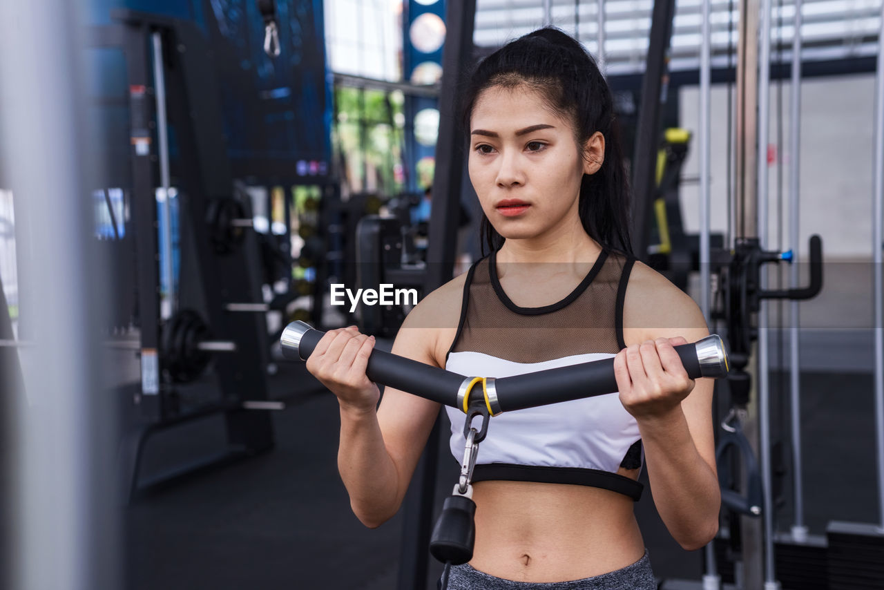 Young woman exercising in gym