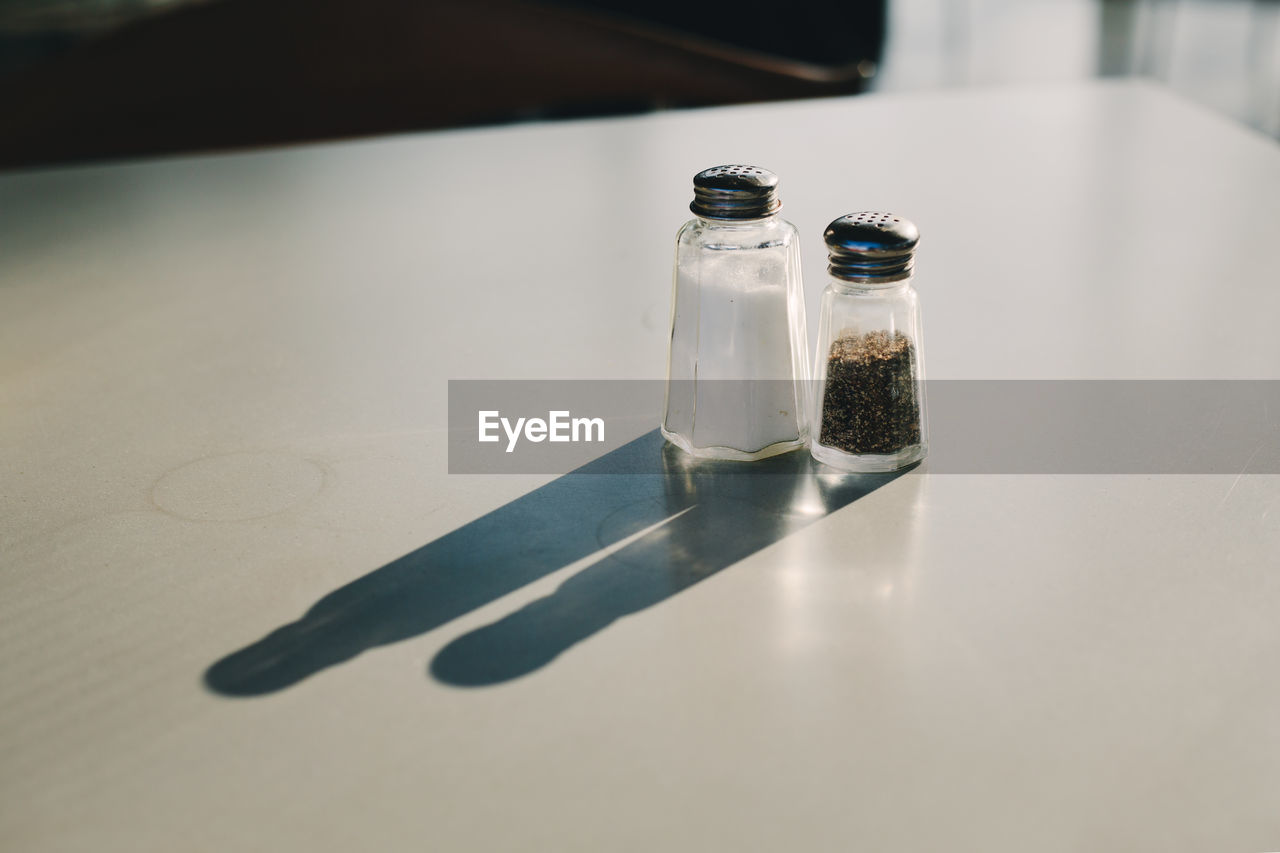 Salt and pepper shakers on table