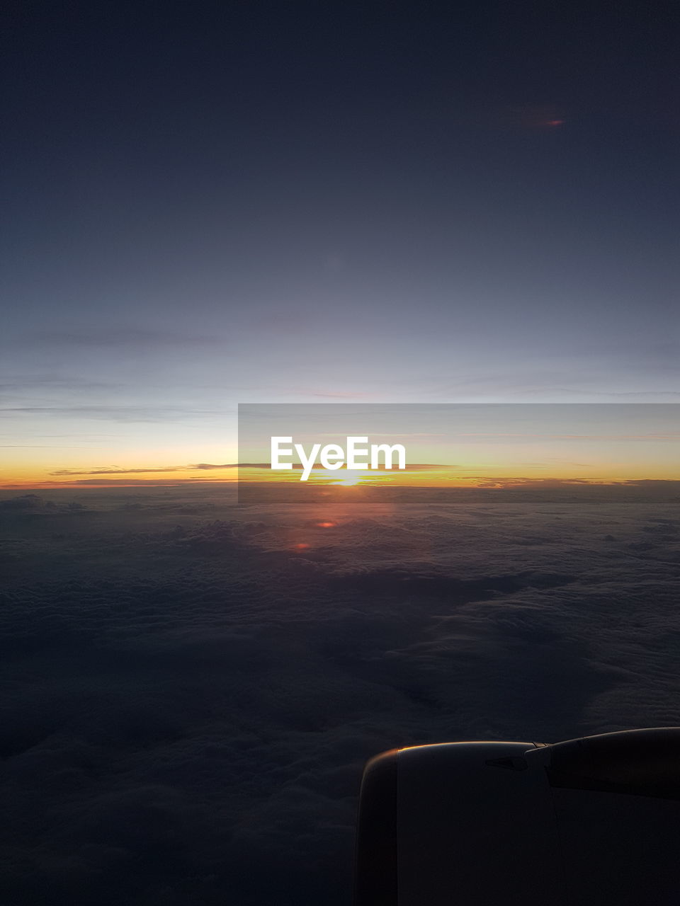 Airplane flying in sky during sunset