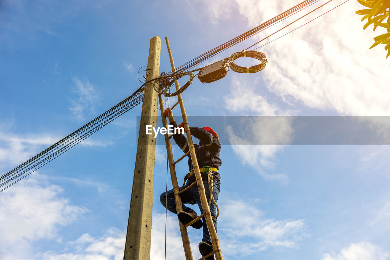 Low angle view of electricity pylon against sky