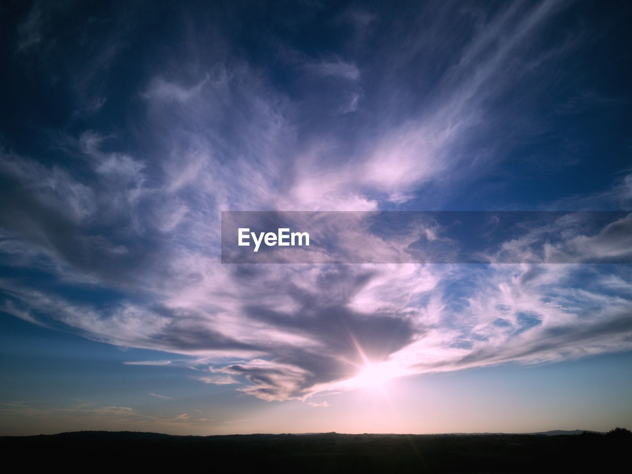 Low angle view of cloudy sky during sunset