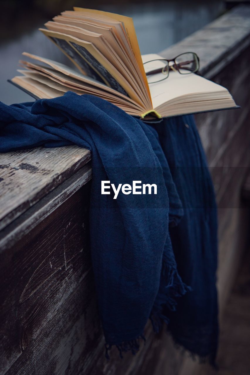 Midsection of man reading book on table