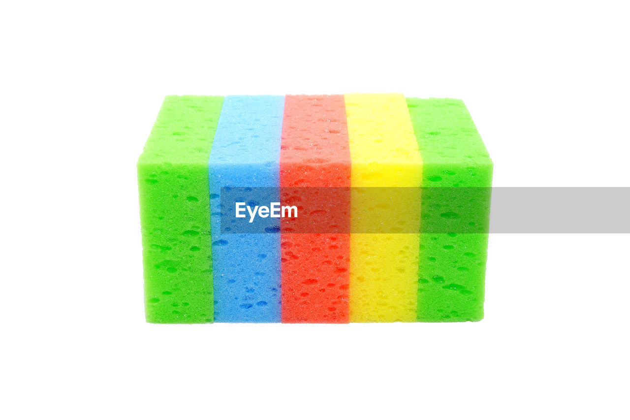 Close-up of multi colored cleaning sponges over white background