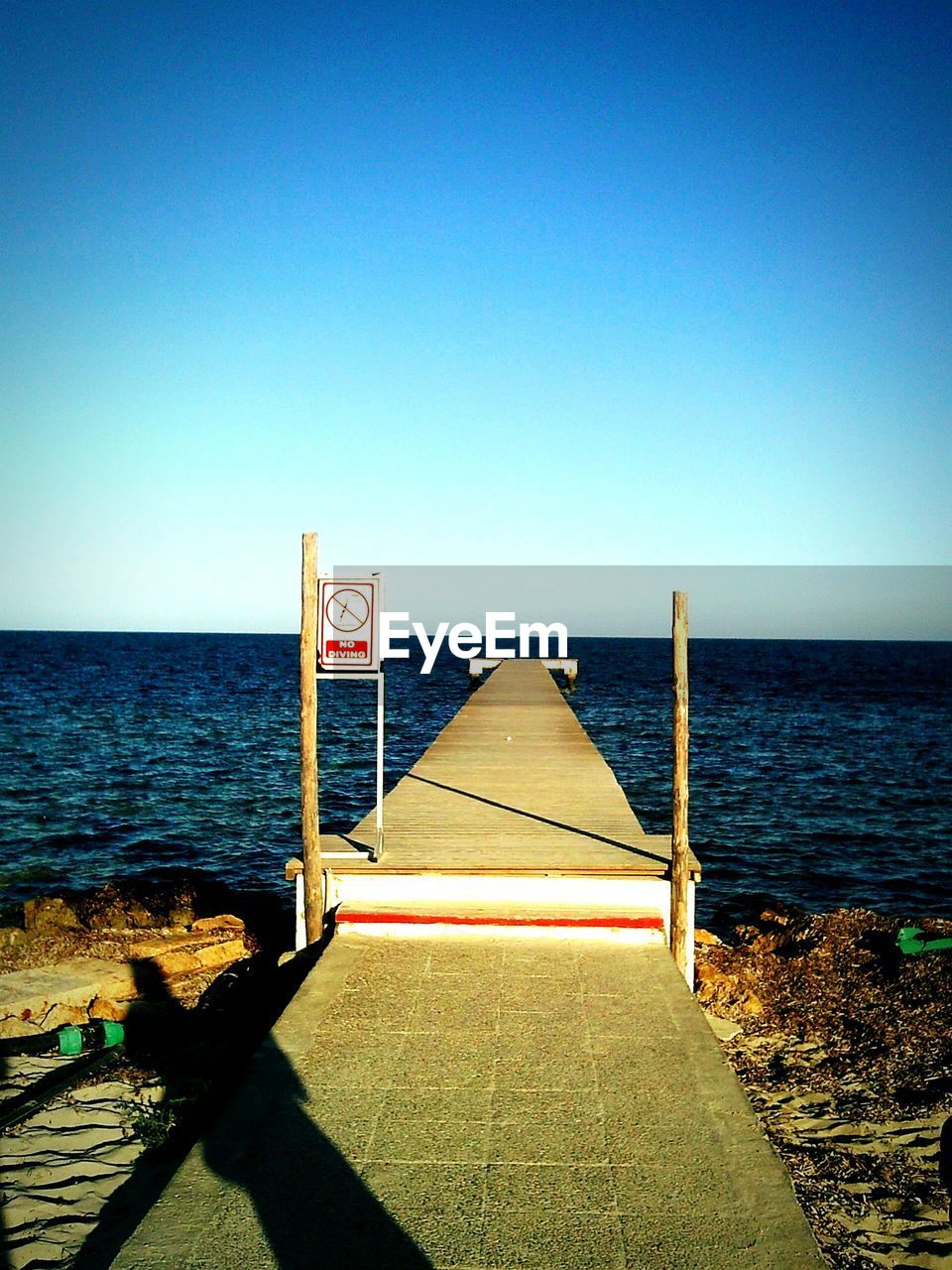 Pier over sea against clear sky