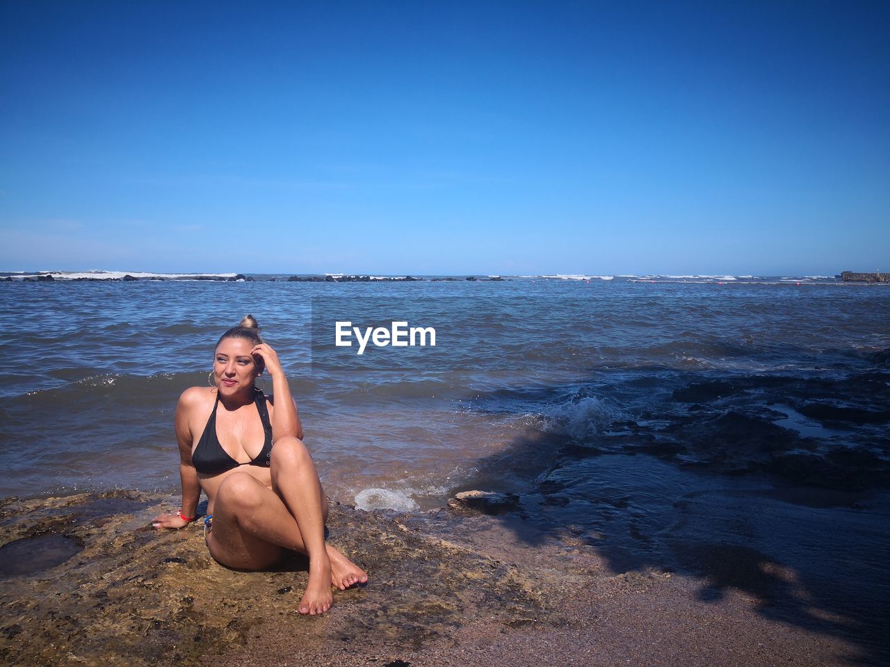 FULL LENGTH OF WOMAN ON BEACH AGAINST SKY