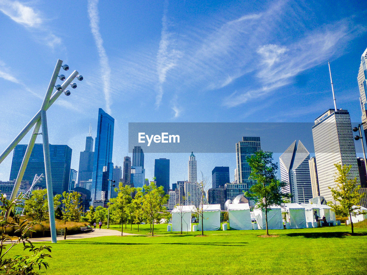 LOW ANGLE VIEW OF CITY SKYLINE AGAINST BLUE SKY