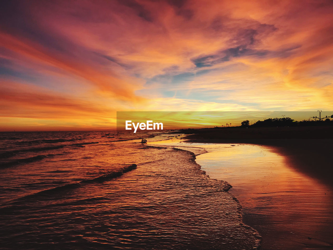 Scenic view of beach against sky during sunset