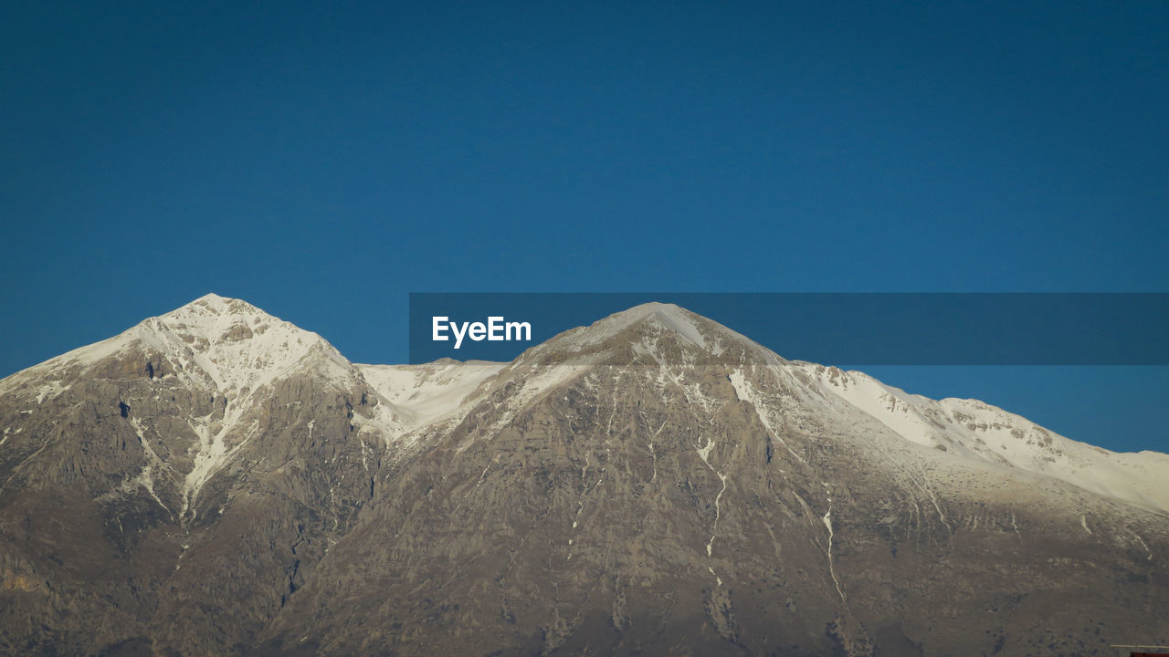 Monte velino, abruzzo italy.  apennines.  mountain range with snowy peaks and blue sky.