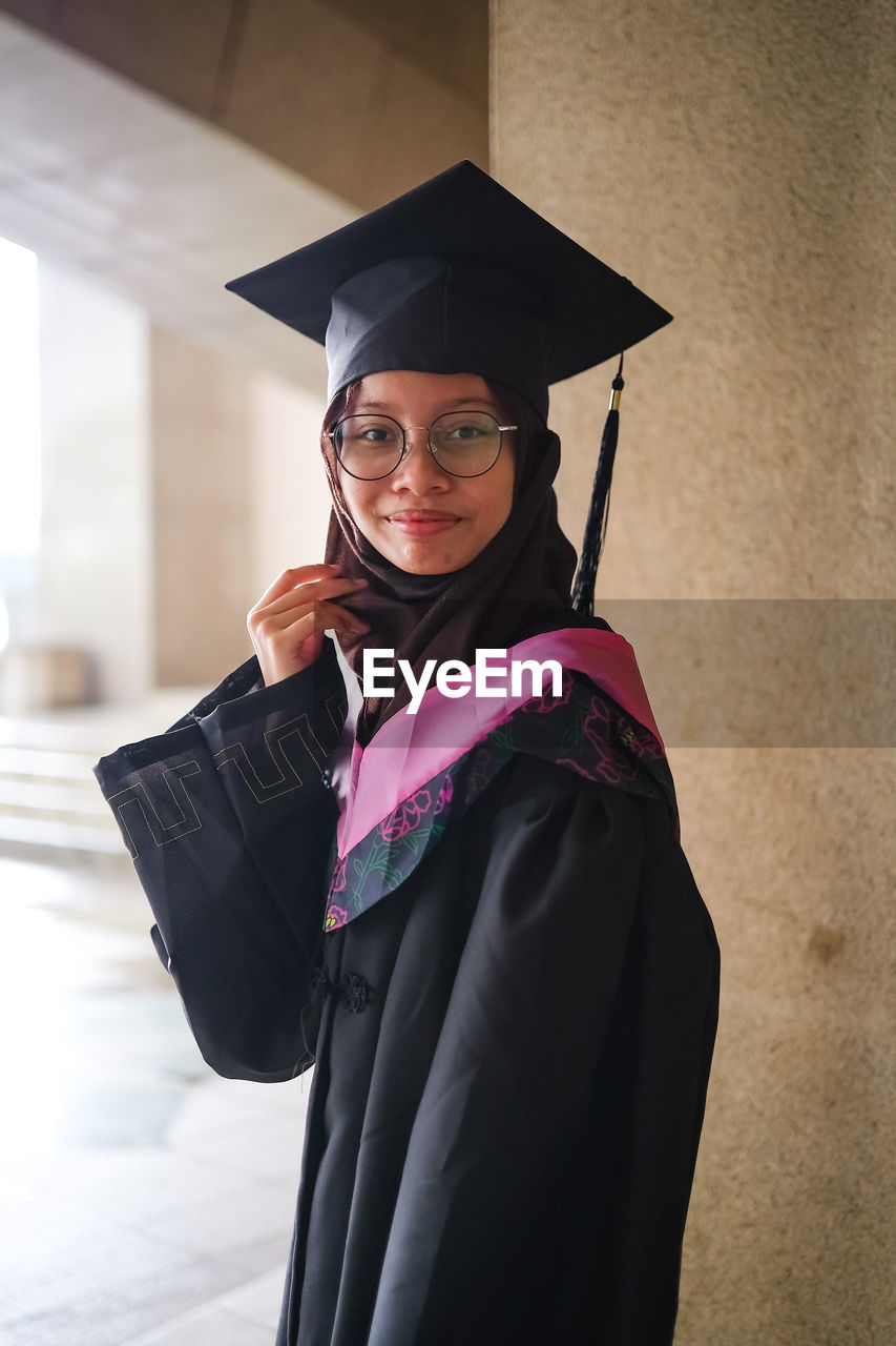 Portrait of woman wearing graduation gown