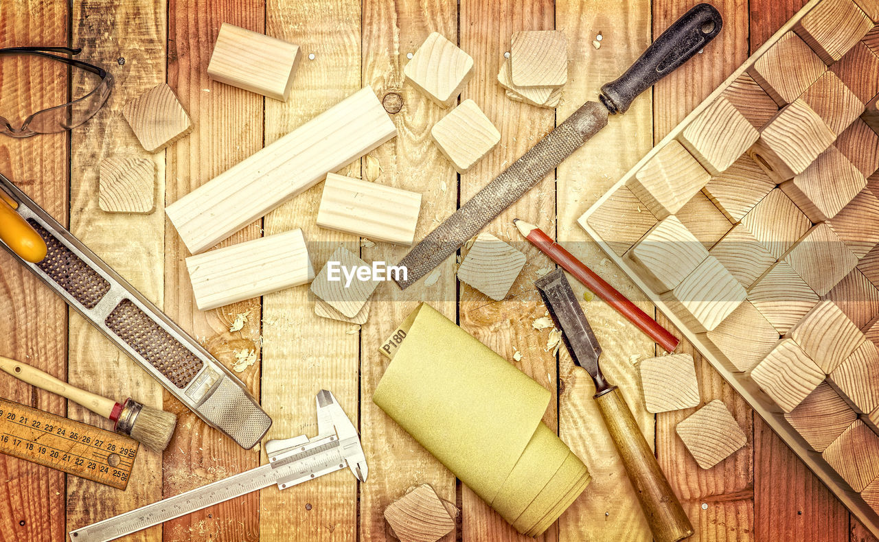 Close-up of work tools on wooden table