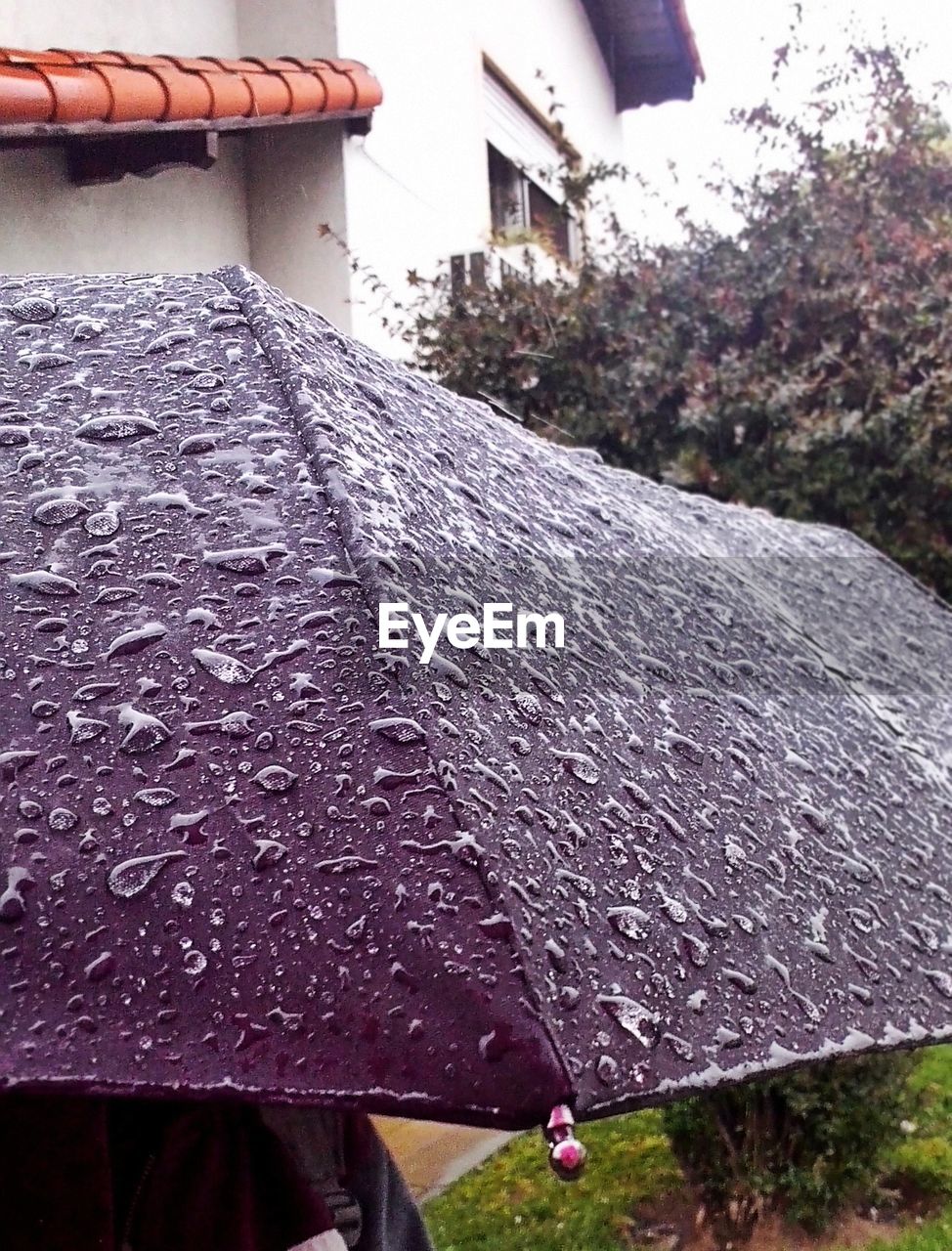 Wet umbrella against house during monsoon