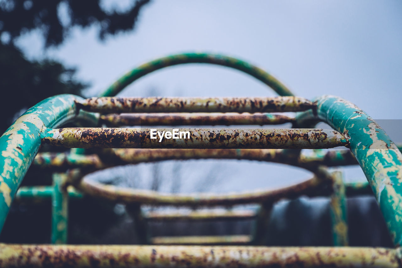 Close-up of rusty monkey bars at playground