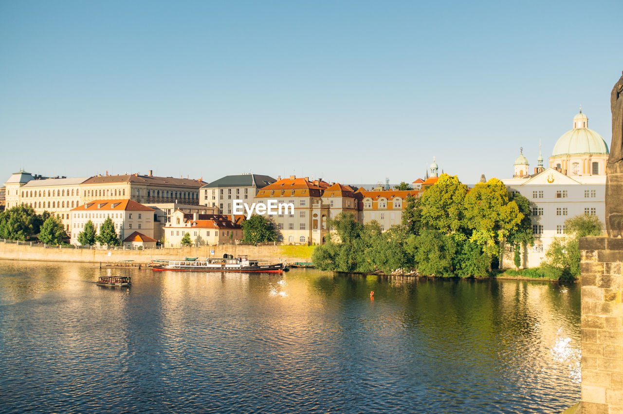 High angle view of ship in river against buildings and clear sky in city