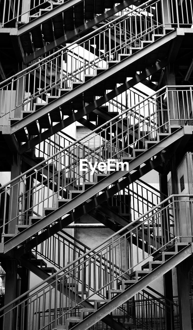 LOW ANGLE VIEW OF STAIRS WITH BUILDING IN BACKGROUND