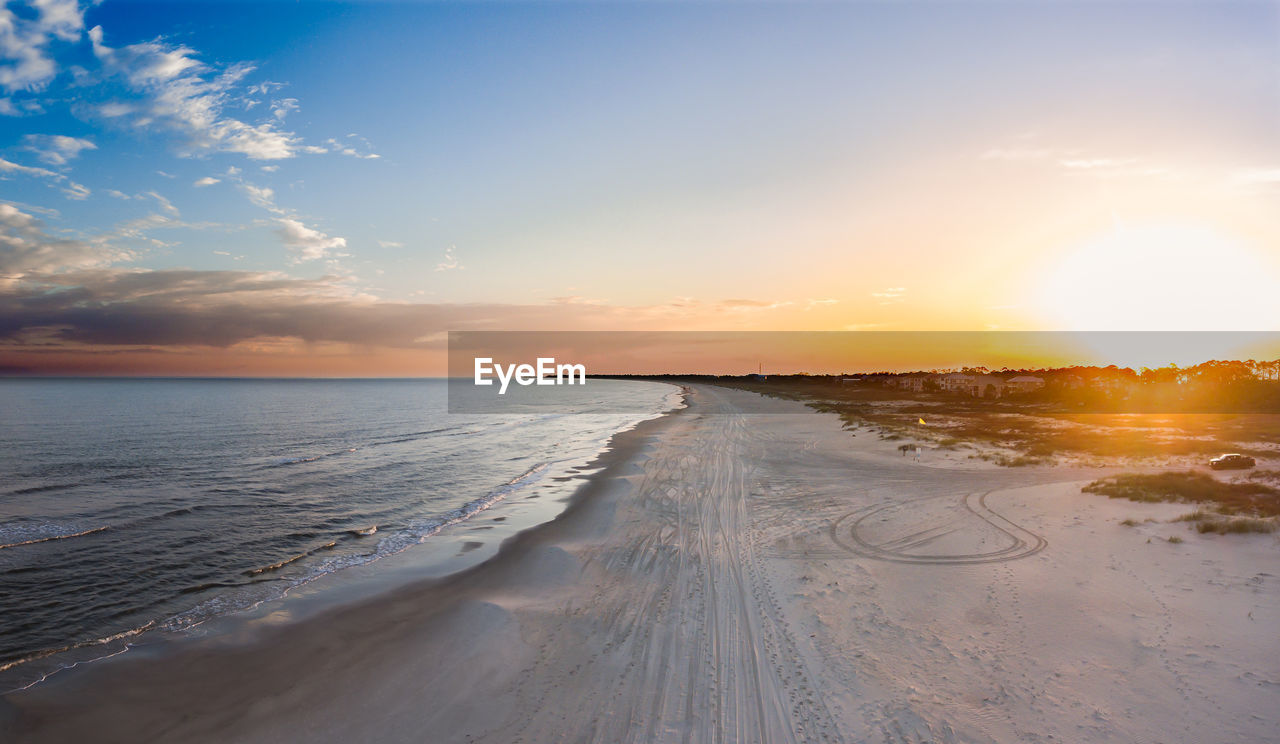 SCENIC VIEW OF BEACH DURING SUNSET