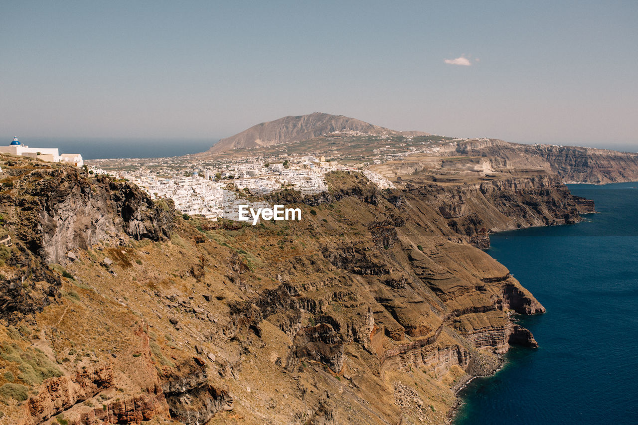 Scenic view of sea and mountains against clear sky