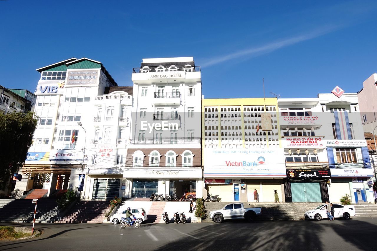 City street by buildings against sky