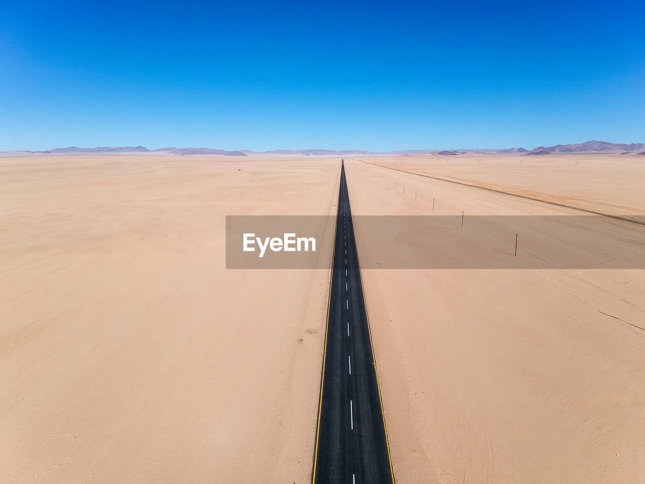 Drone - straight b4 desert road and train line between lüderitz and keetmanshoop in namibia, africa.