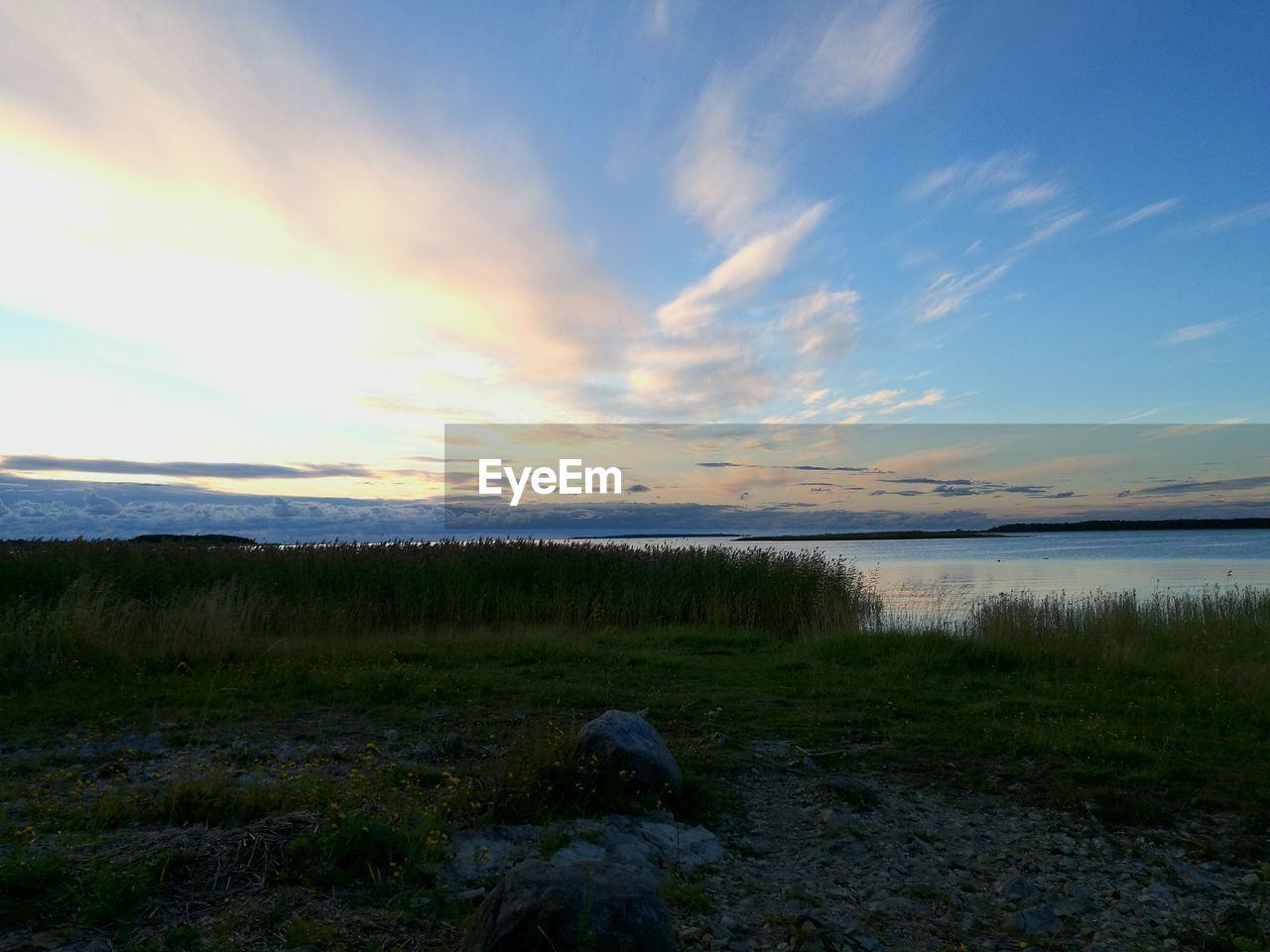 SCENIC VIEW OF LANDSCAPE WITH RIVER IN BACKGROUND