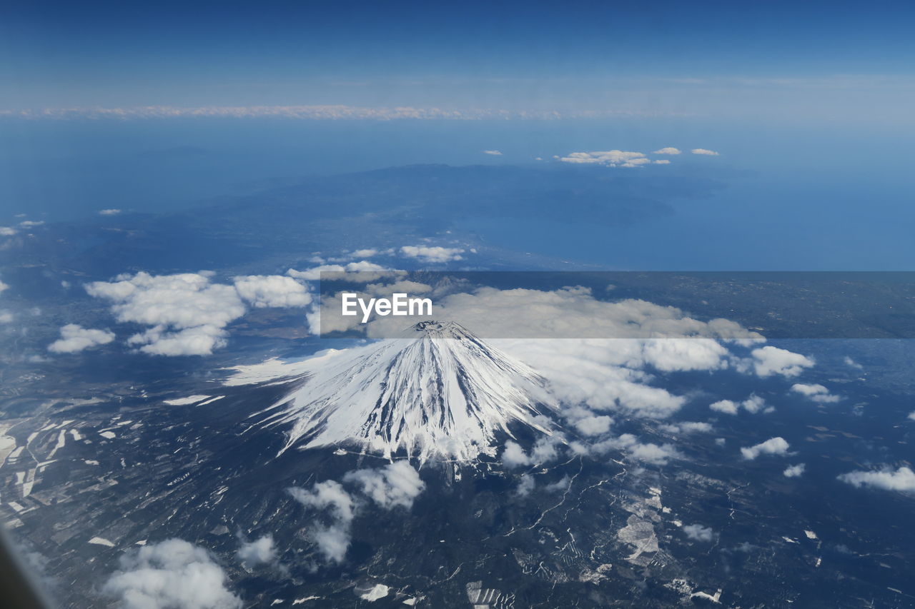 Aerial view of snowcapped mountains against sky