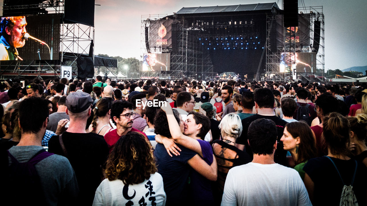 GROUP OF PEOPLE AT MUSIC CONCERT