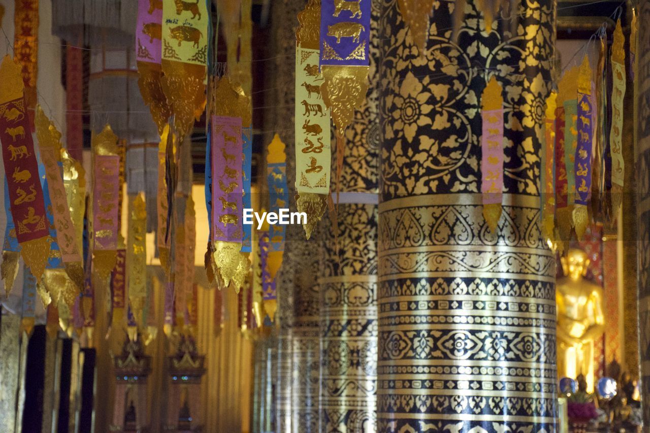 CLOSE-UP OF MULTI COLORED CLOTHES HANGING AT MARKET STALL