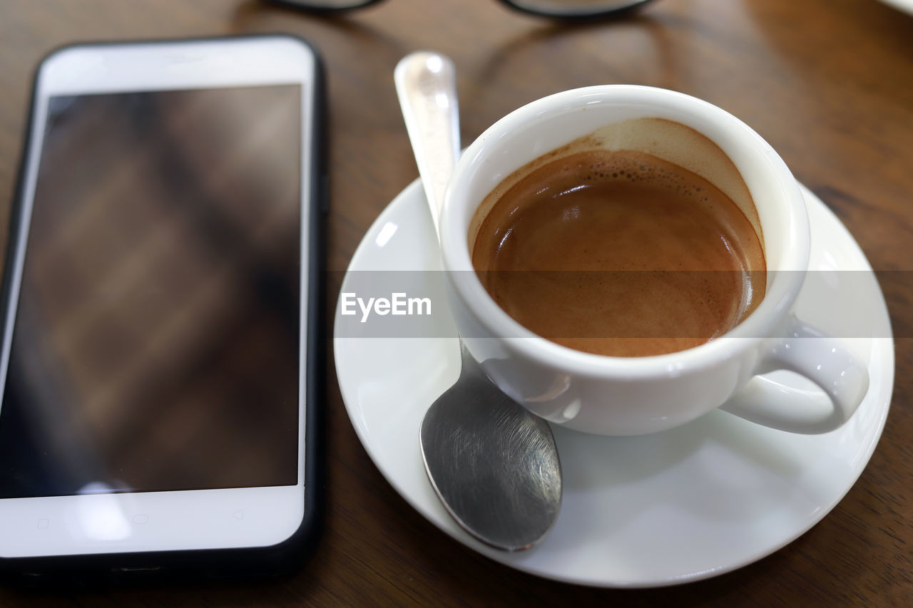 High angle view of coffee cup on table