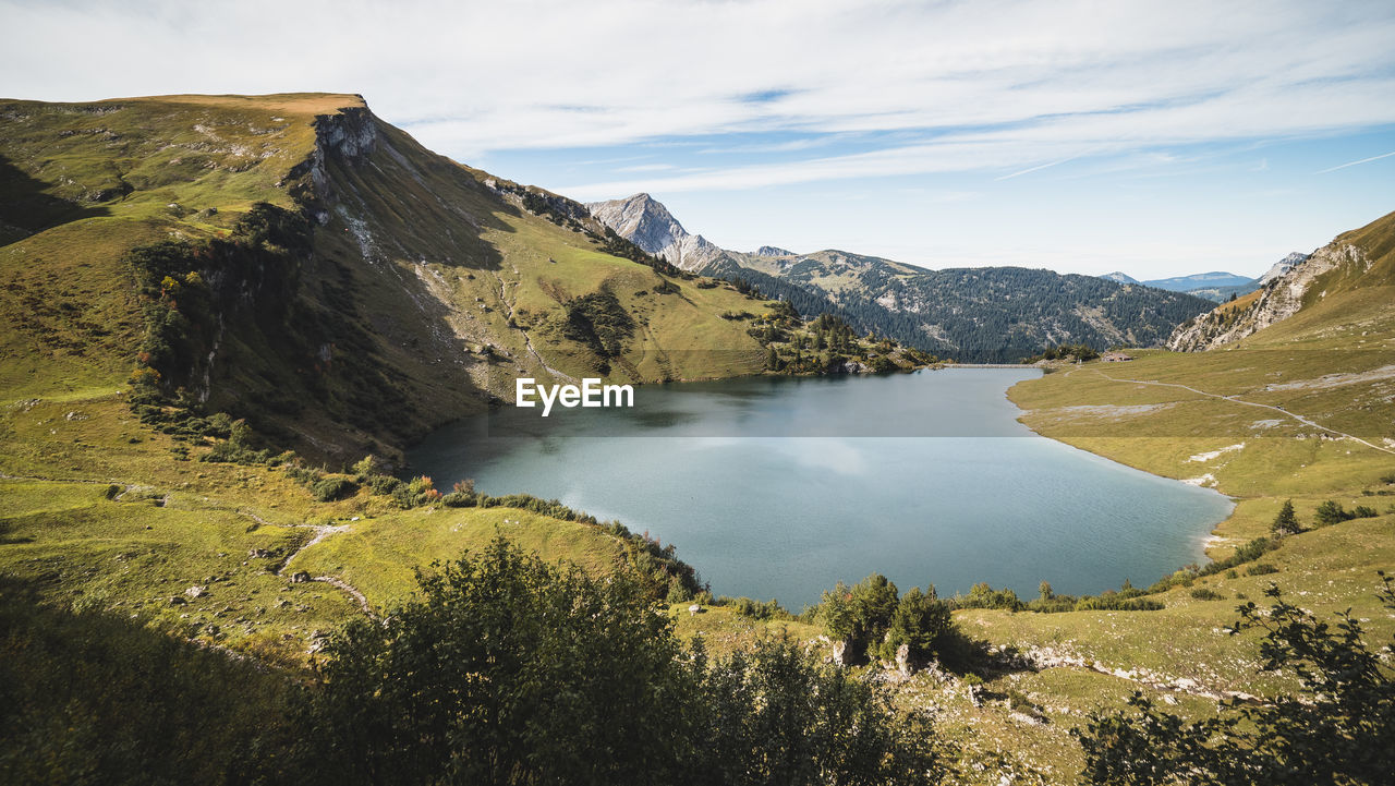 Scenic view of landscape and mountains against sky