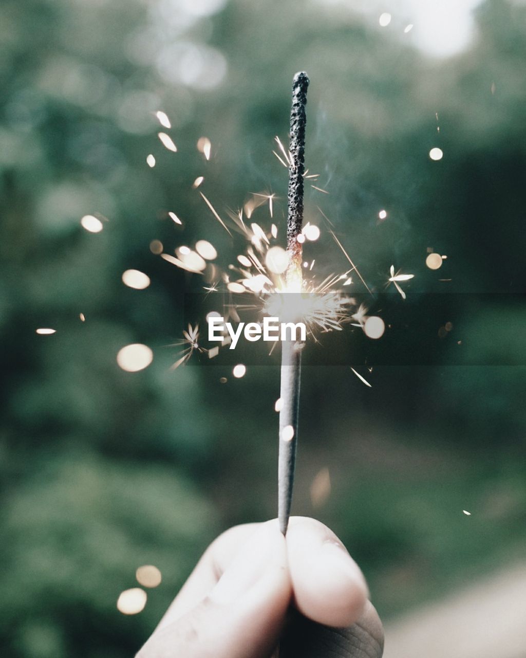 Close-up of hand holding sparkler